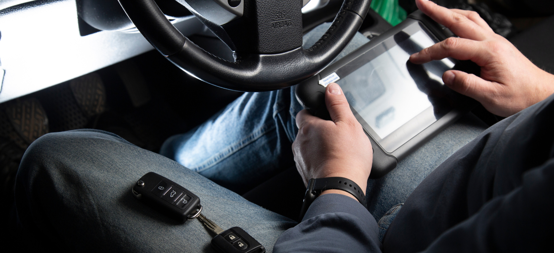 Auto locksmith using professional key programming equipment